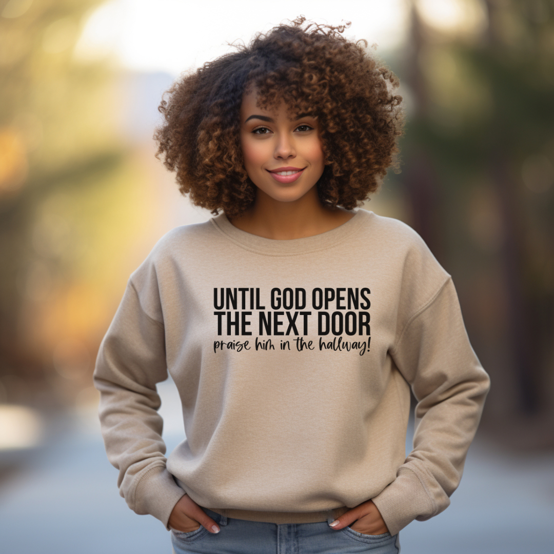 Sand Unisex Crewneck Sweatshirt "Until Gopd Opens The Next Door Praise Him In The Hallway