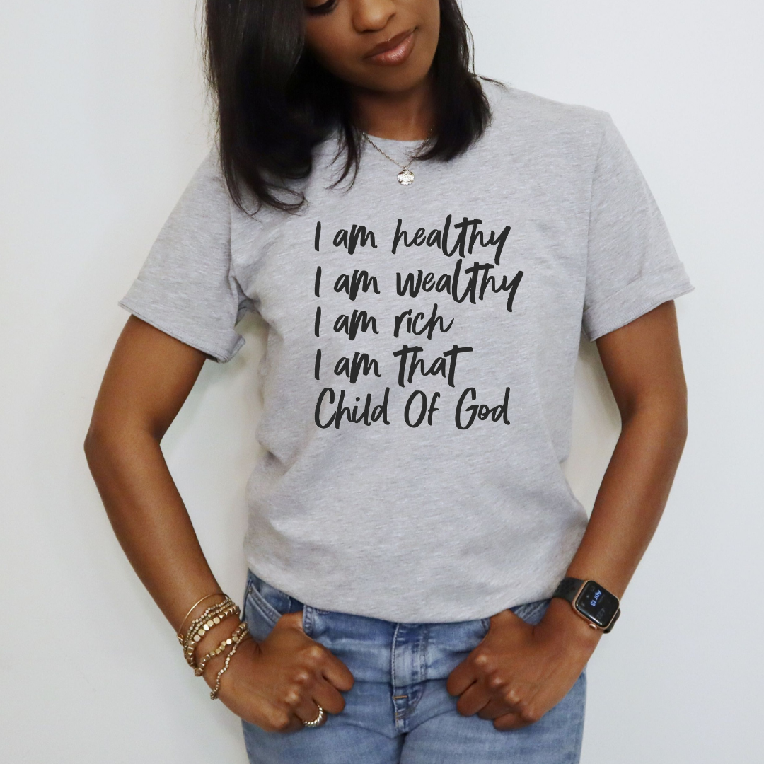 I am healthy, I am wealthy, I am rich, I am that, child of God gray unisex gray short sleeve Faith based t-shirt with black writing. 